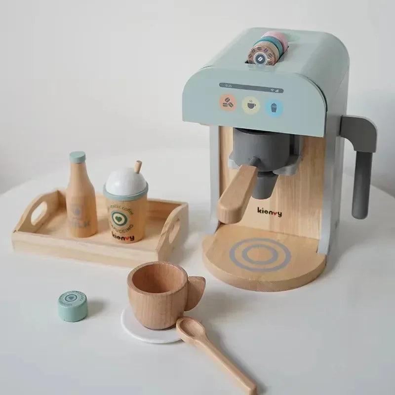 Children's toy coffee set with a espresso machine, cups, and bottles on a white surface.